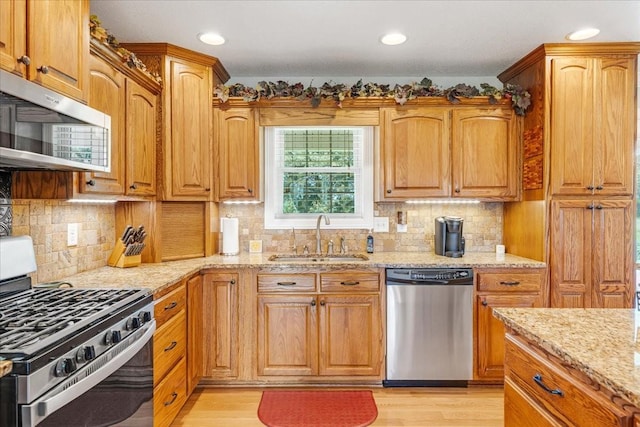 379 Hooper Rd, Winchester, TN 37398 - kitchen with stainless steel appliances, light stone countertops, light wood finished floors, tasteful backsplash, and recessed lighting