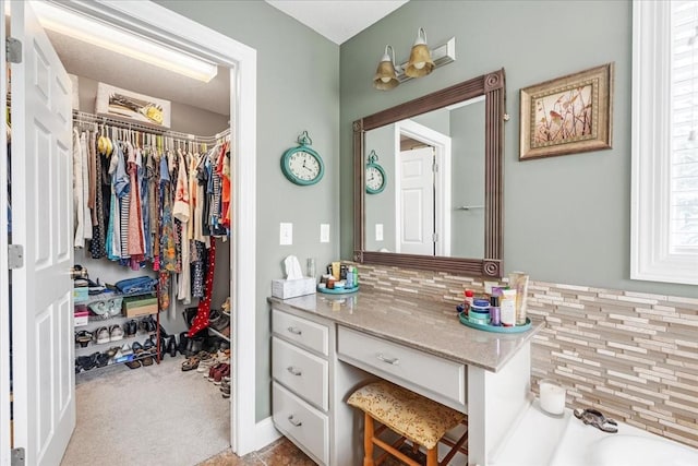 379 Hooper Rd, Winchester, TN 37398 - bathroom with a spacious closet, vanity, and tasteful backsplash