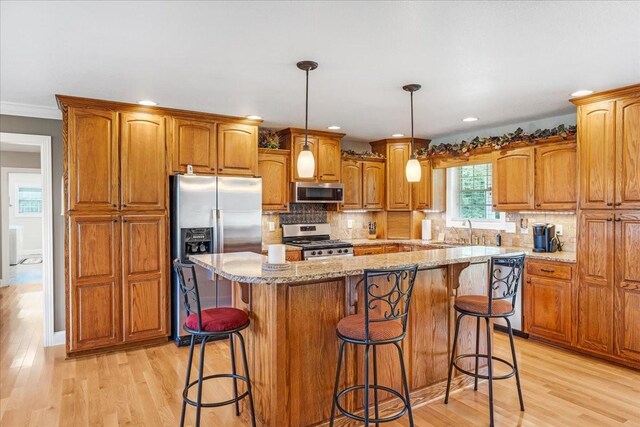 379 Hooper Rd, Winchester, TN 37398 - kitchen featuring appliances with stainless steel finishes, light wood finished floors, brown cabinets, light stone counters, and recessed lighting