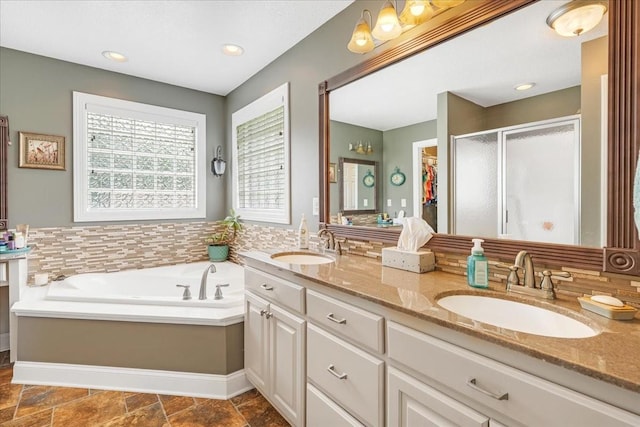 379 Hooper Rd, Winchester, TN 37398 - bathroom with double vanity, a stall shower, a garden tub, and stone finish floors