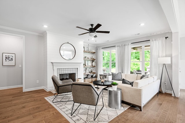 2636 Bramblewood Ln, Thompsons Station, TN 37179 - living area featuring a ceiling fan, a fireplace, recessed lighting, wood finished floors, and ornamental molding