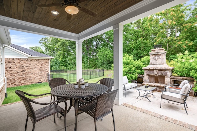 2636 Bramblewood Ln, Thompsons Station, TN 37179 - view of patio featuring an outdoor stone fireplace, a ceiling fan, view of scattered trees, and outdoor dining area