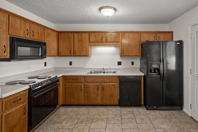 3230 S Senseney Cir, Clarksville, TN 37042 - kitchen with black appliances, brown cabinets, light countertops, and a textured ceiling