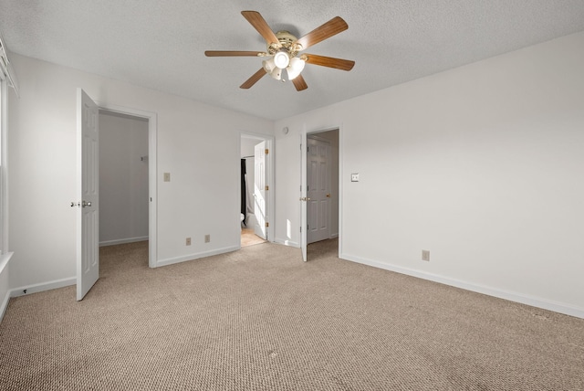 3230 S Senseney Cir, Clarksville, TN 37042 - unfurnished bedroom featuring light carpet, a walk in closet, ceiling fan, a textured ceiling, and ensuite bathroom