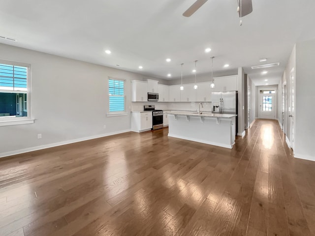 795 Ewell Farm Dr, Spring Hill, TN 37174 - unfurnished living room featuring healthy amount of natural light, dark wood finished floors, a ceiling fan, and recessed lighting