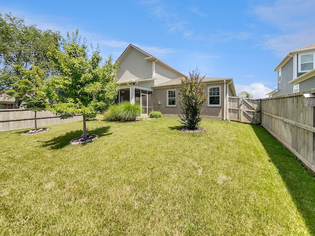 795 Ewell Farm Dr, Spring Hill, TN 37174 - back of house featuring a fenced backyard, a sunroom, and a gate