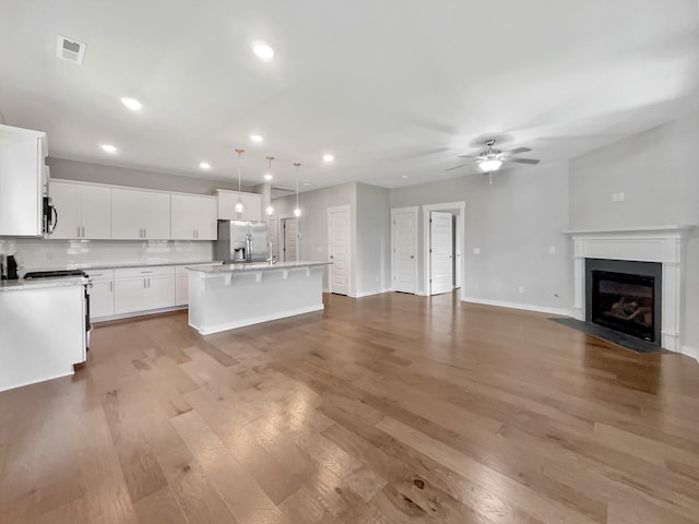 795 Ewell Farm Dr, Spring Hill, TN 37174 - kitchen featuring appliances with stainless steel finishes, a ceiling fan, open floor plan, light wood-style flooring, and light countertops