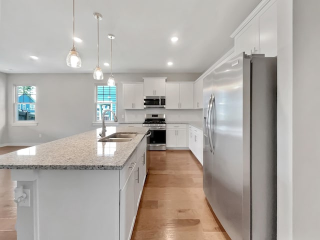 795 Ewell Farm Dr, Spring Hill, TN 37174 - kitchen featuring appliances with stainless steel finishes, plenty of natural light, white cabinets, a kitchen island with sink, and recessed lighting