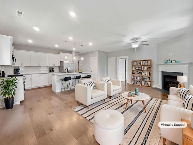 795 Ewell Farm Dr, Spring Hill, TN 37174 - living area featuring a ceiling fan, light wood-style floors, recessed lighting, and a fireplace with flush hearth