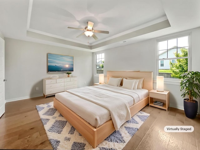 795 Ewell Farm Dr, Spring Hill, TN 37174 - bedroom with a raised ceiling, wood finished floors, and a ceiling fan