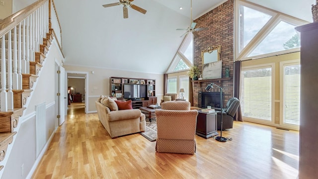 938 Thompson Rd, Pegram, TN 37143 - living area with high vaulted ceiling, stairs, a ceiling fan, and light wood-type flooring