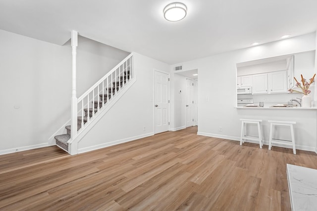 601 Boyd Mill Ave Unit O4, Franklin, TN 37064 - unfurnished living room with stairway, light wood-type flooring, and recessed lighting