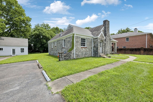 234 4th Ave N, Franklin, TN 37064 - view of front of home featuring stone siding, a chimney, a shingled roof, and uncovered parking