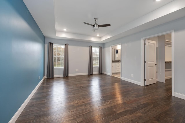 33 Maple Ln, Summertown, TN 38483 - unfurnished bedroom featuring dark wood-style flooring, recessed lighting, a tray ceiling, a spacious closet, and a ceiling fan
