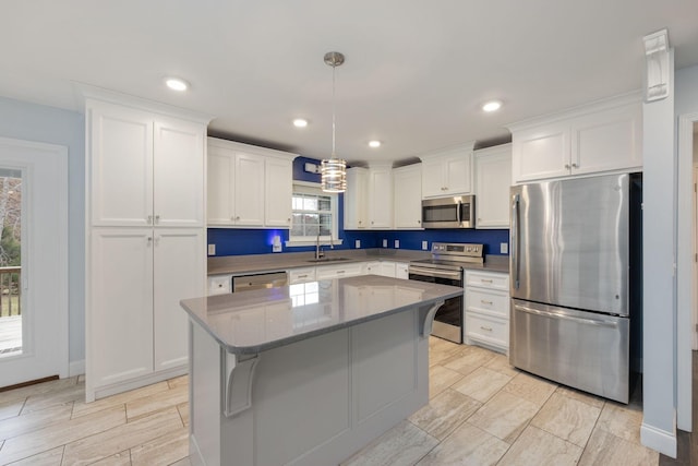 33 Maple Ln, Summertown, TN 38483 - kitchen with stainless steel appliances, white cabinets, a kitchen island, pendant lighting, and recessed lighting
