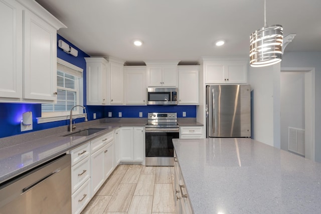 33 Maple Ln, Summertown, TN 38483 - kitchen featuring stainless steel appliances, white cabinets, dark stone counters, hanging light fixtures, and recessed lighting