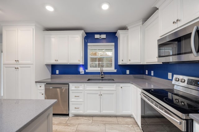 33 Maple Ln, Summertown, TN 38483 - kitchen with appliances with stainless steel finishes, white cabinets, light stone countertops, and recessed lighting