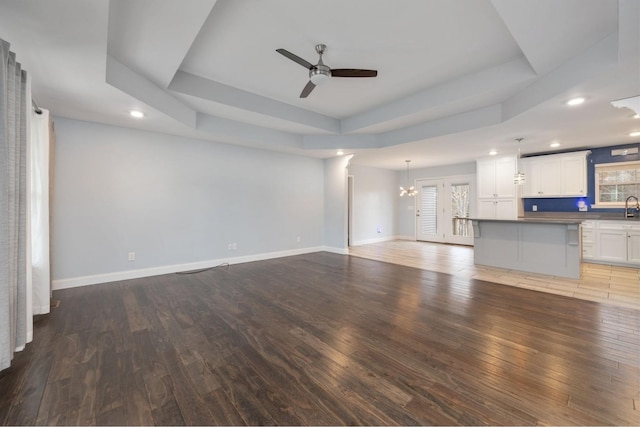 33 Maple Ln, Summertown, TN 38483 - unfurnished living room with a ceiling fan, wood finished floors, recessed lighting, a tray ceiling, and a chandelier