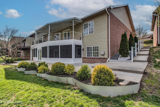 57 Riverview Dr, Oak Ridge, TN 37830 - rear view of house with brick siding, a balcony, a sunroom, and a yard