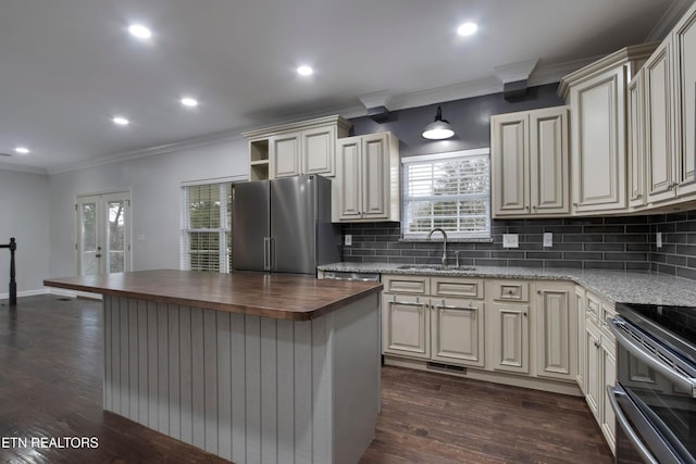 57 Riverview Dr, Oak Ridge, TN 37830 - kitchen featuring wooden counters, stainless steel appliances, tasteful backsplash, ornamental molding, and cream cabinets