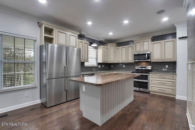57 Riverview Dr, Oak Ridge, TN 37830 - kitchen featuring stainless steel appliances, butcher block counters, cream cabinetry, a kitchen island, and decorative backsplash