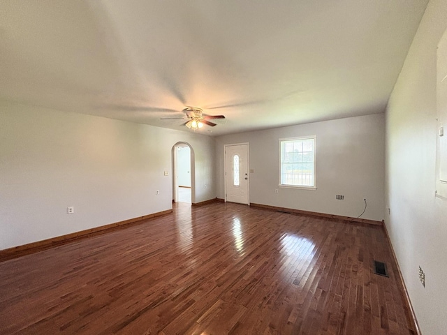 571 E Main St, Auburn, KY 42206 - unfurnished living room with wood finished floors, arched walkways, and a ceiling fan