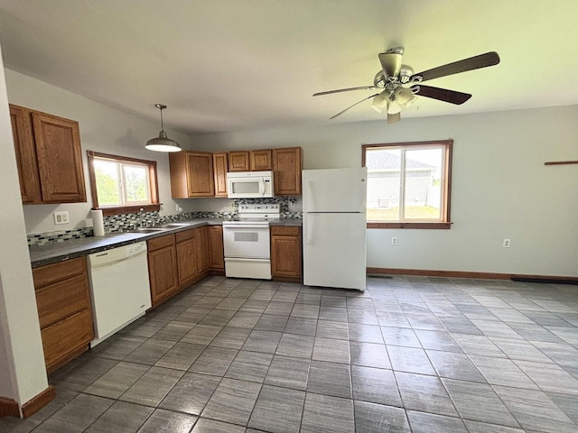 571 E Main St, Auburn, KY 42206 - kitchen with white appliances, dark countertops, ceiling fan, tile patterned flooring, and brown cabinets