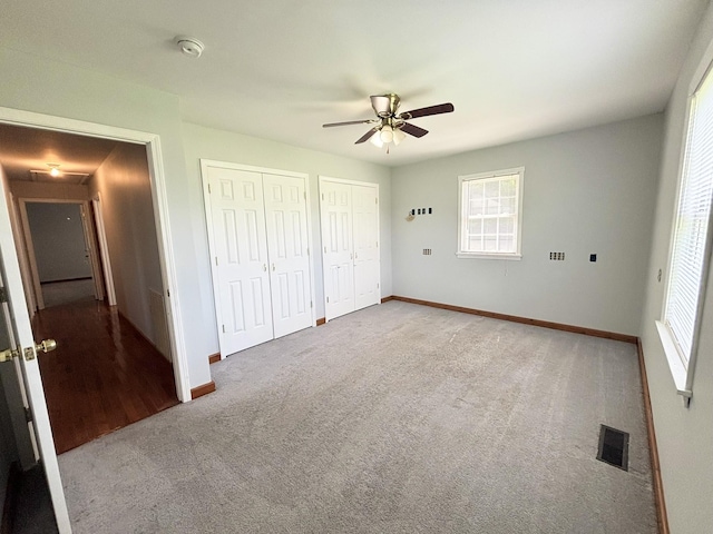 571 E Main St, Auburn, KY 42206 - unfurnished bedroom featuring multiple closets, carpet floors, and ceiling fan