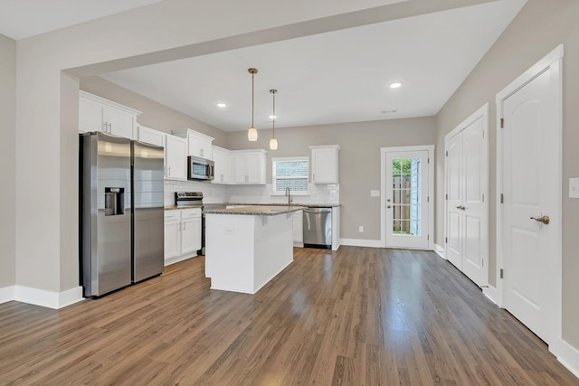127 Dry Creek Commons Dr, Goodlettsville, TN 37072 - kitchen with appliances with stainless steel finishes, tasteful backsplash, white cabinetry, wood finished floors, and recessed lighting