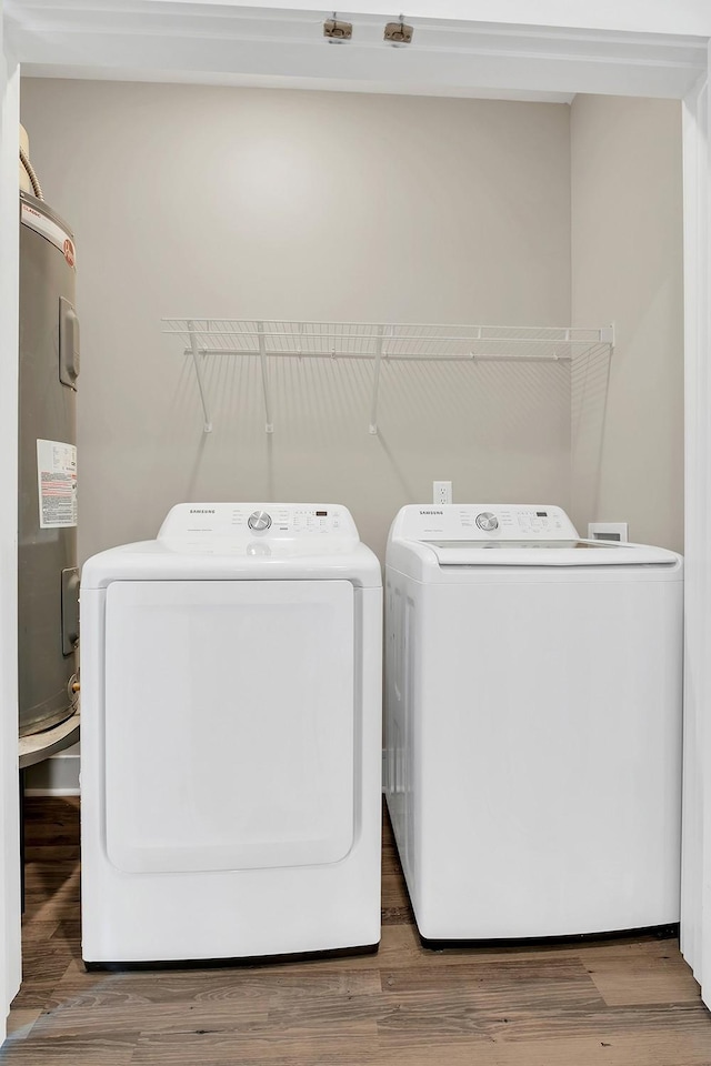 127 Dry Creek Commons Dr, Goodlettsville, TN 37072 - laundry room featuring electric water heater, washer and clothes dryer, and wood finished floors