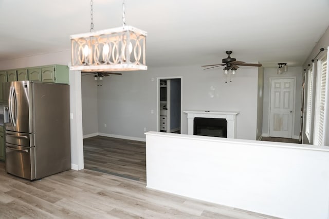 31 Community Rd, Lawrenceburg, TN 38464 - kitchen with stainless steel fridge with ice dispenser, a ceiling fan, green cabinets, open floor plan, and light wood-style flooring