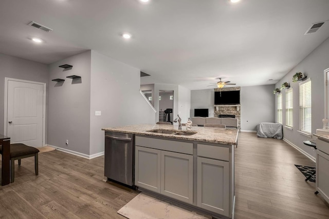 3210 Chatfield Dr, Murfreesboro, TN 37129 - kitchen with stainless steel dishwasher, a fireplace, ceiling fan, gray cabinetry, and dark wood-type flooring