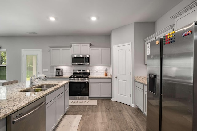 3210 Chatfield Dr, Murfreesboro, TN 37129 - kitchen with appliances with stainless steel finishes, dark wood finished floors, backsplash, light stone countertops, and recessed lighting