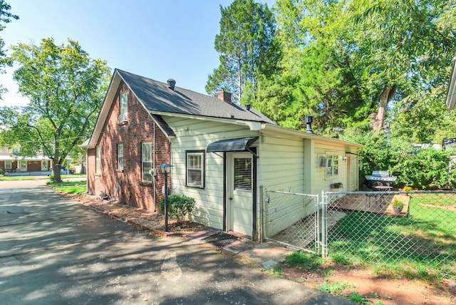 203 6th Ave, Columbia, TN 38401 - view of property exterior with brick siding, a gate, and a chimney