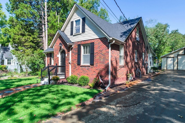 203 6th Ave, Columbia, TN 38401 - tudor house with brick siding, an outbuilding, a front lawn, a garage, and a shingled roof