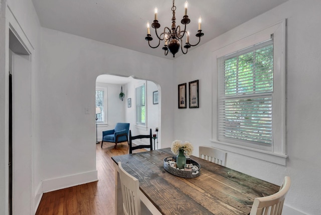 203 6th Ave, Columbia, TN 38401 - dining space with arched walkways, a chandelier, and dark wood-type flooring