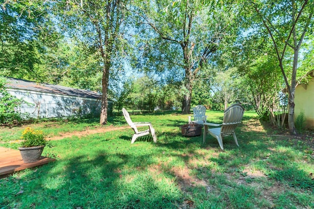 203 6th Ave, Columbia, TN 38401 - view of grassy yard featuring an outdoor fire pit and a deck