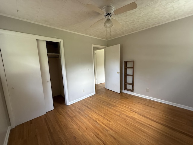 125 Benco Ln, Camden, TN 38320 - unfurnished bedroom with ornamental molding, wood finished floors, a closet, and a ceiling fan