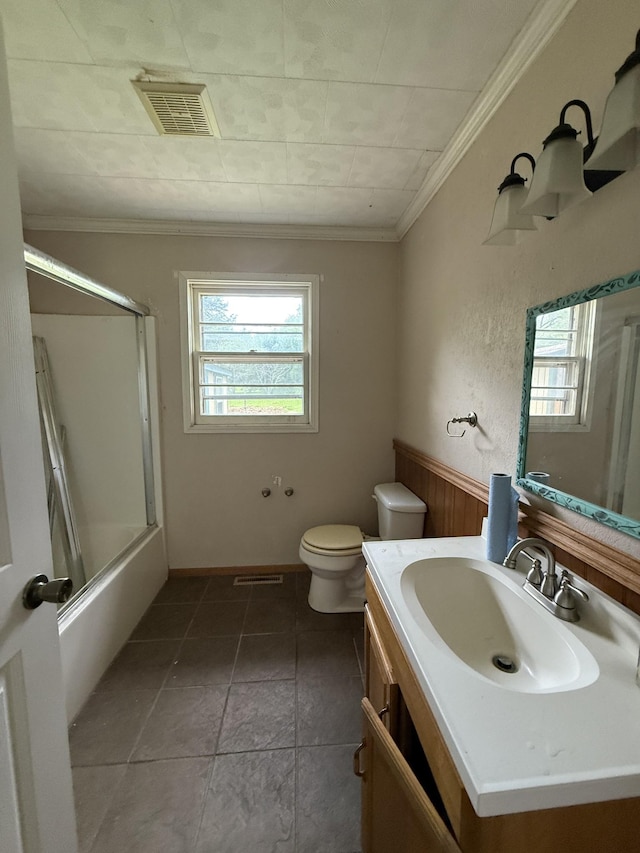 125 Benco Ln, Camden, TN 38320 - full bath featuring ornamental molding, vanity, healthy amount of natural light, enclosed tub / shower combo, and wainscoting