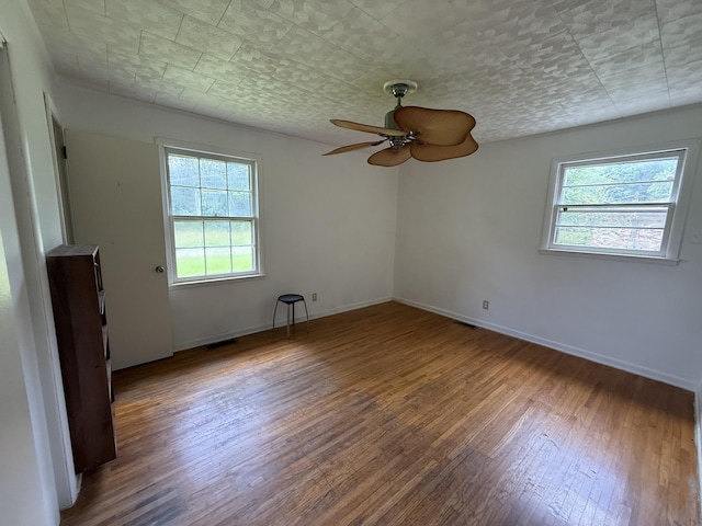 125 Benco Ln, Camden, TN 38320 - unfurnished room featuring plenty of natural light, wood finished floors, and a ceiling fan