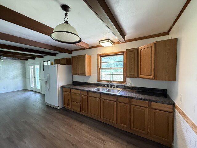 125 Benco Ln, Camden, TN 38320 - kitchen with white fridge with ice dispenser, beamed ceiling, dark countertops, brown cabinetry, and dark wood-style flooring