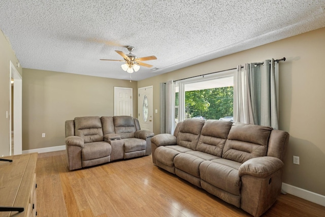 5 Old Chisholm Creek Rd, Lawrenceburg, TN 38464 - living room featuring a ceiling fan, light wood-style floors, and a textured ceiling