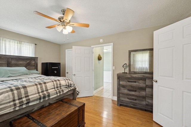 5 Old Chisholm Creek Rd, Lawrenceburg, TN 38464 - bedroom with light wood finished floors, a ceiling fan, and a textured ceiling