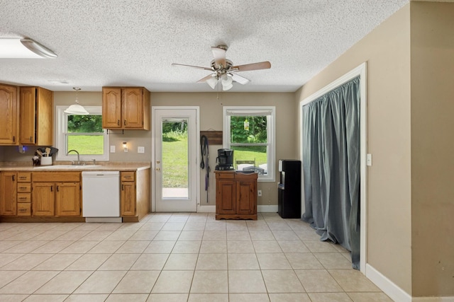 5 Old Chisholm Creek Rd, Lawrenceburg, TN 38464 - kitchen featuring white dishwasher, light countertops, a ceiling fan, brown cabinets, and a textured ceiling