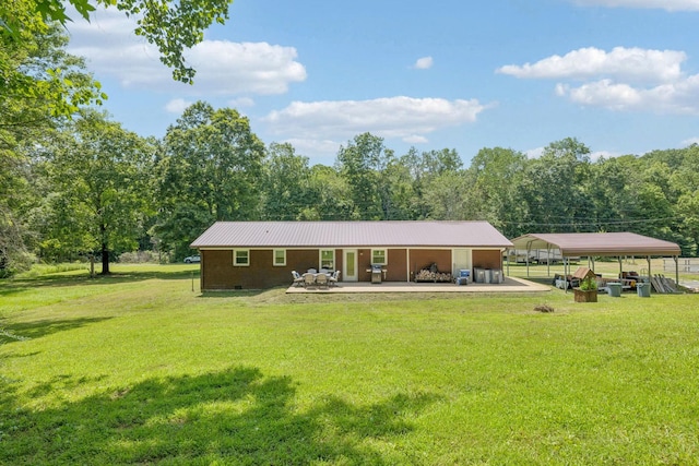 5 Old Chisholm Creek Rd, Lawrenceburg, TN 38464 - back of house with a detached carport, a yard, a metal roof, and crawl space