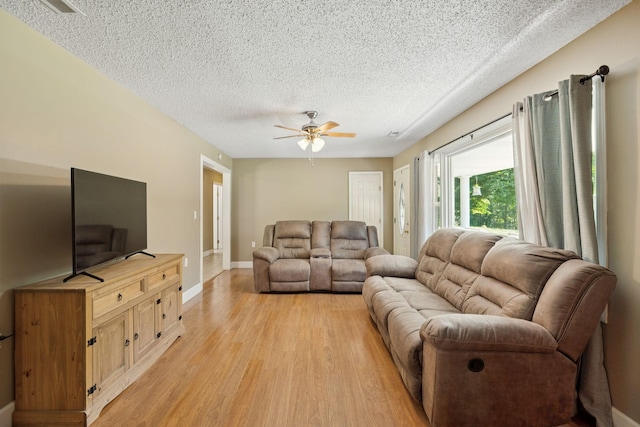 5 Old Chisholm Creek Rd, Lawrenceburg, TN 38464 - living area with light wood-style flooring, a textured ceiling, and ceiling fan