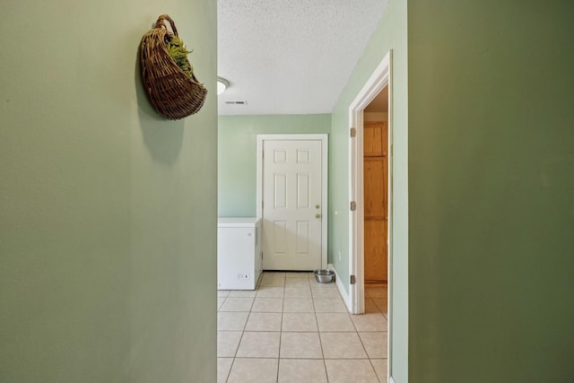 5 Old Chisholm Creek Rd, Lawrenceburg, TN 38464 - hallway featuring washer / dryer, light tile patterned flooring, and a textured ceiling
