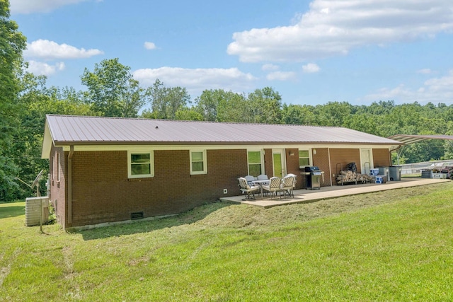 5 Old Chisholm Creek Rd, Lawrenceburg, TN 38464 - rear view of property with brick siding, a yard, a patio, crawl space, and a metal roof