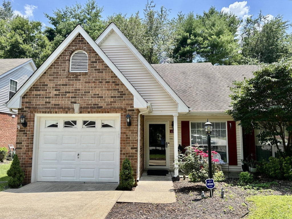 610 Messick Ct, Murfreesboro, TN 37130 - view of front of house with concrete driveway, roof with shingles, a garage, and brick siding
