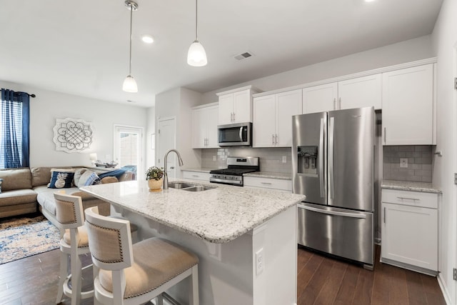 4206 Grapevine Loop, Smyrna, TN 37167 - kitchen with stainless steel appliances, open floor plan, dark wood-style floors, white cabinetry, and decorative backsplash